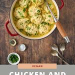 vegan chicken and dumplings in a red pan with serving spoon
